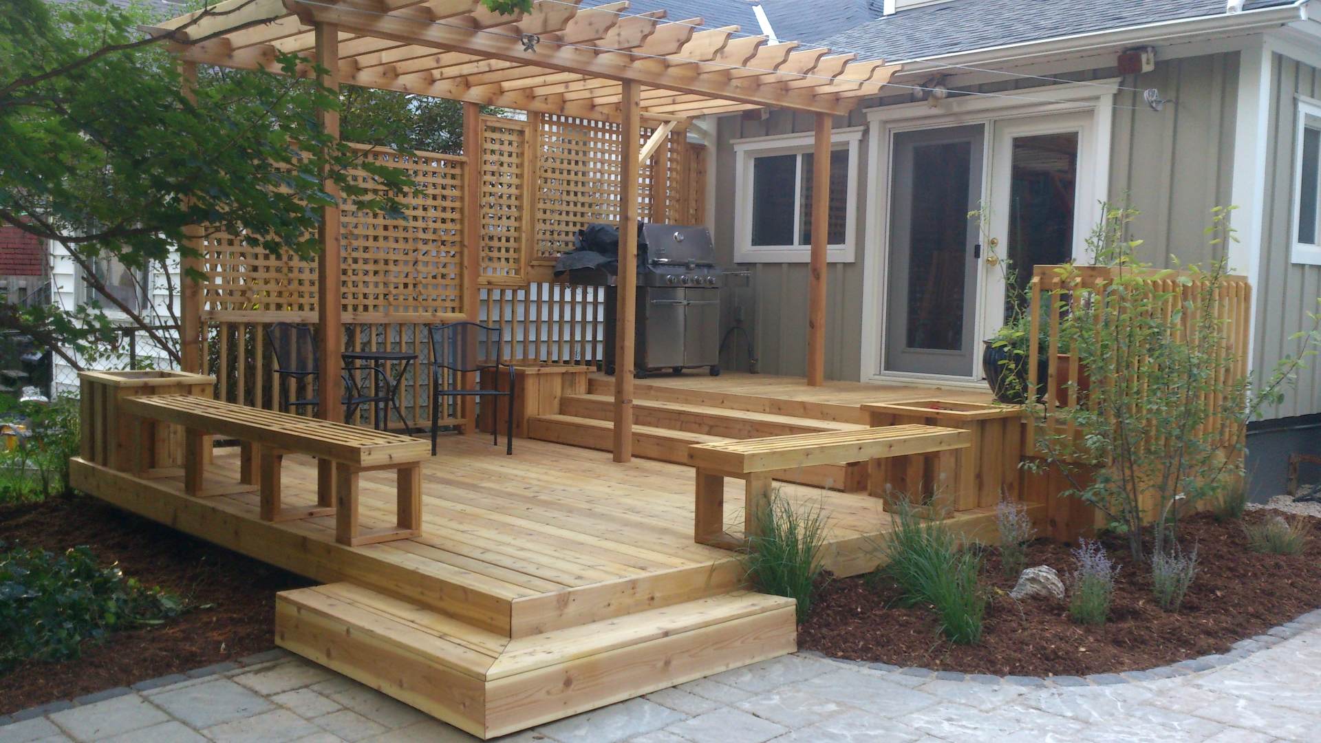 An after photo: backyard and deck renovation, a landscaping and deck woodwork project in London Ontario.