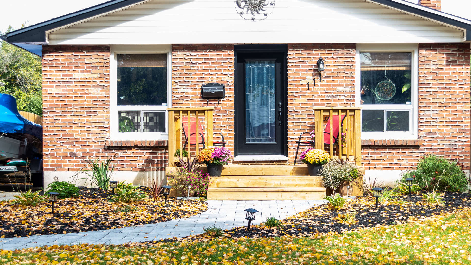 An after photo: landscaping / hardscaping project in London Ontario: natural stone / armour stone steps and retaining wall.