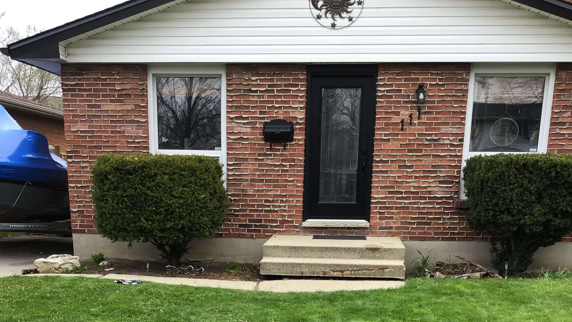 A before photo: landscaping / hardscaping project in London Ontario: natural stone / armour steps and retaining wall.